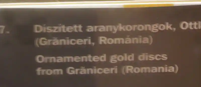 Cross with swirls engraved on a gold disc